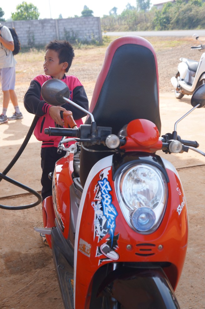 Only in Laos will an 8-year-old pump your gas